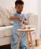 Toddler playing in an ergoPouch Sleep Suit Sack 1.0 TOG Dragonflies, a sleeping bag that converts to a sleeping bag with legs