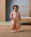 Toddler wearing ergoPouch Sleep Suit Sack 2.5 TOG in legs mode featuring cute elephant print