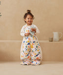 Toddler standing, wearing an ergoPouch Sleep Suit Sack Fruit Salad