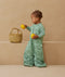 Child standing in an ergoPouch Sleep Suit Sack 3.5 TOG Sweet Orchard, a warm sleeping bag that converts to a sleeping bag with legs
