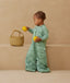 Child standing in an ergoPouch Sleep Suit Sack 3.5 TOG Sweet Orchard, a warm sleeping bag that converts to a sleeping bag with legs
