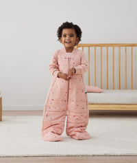 Toddler standing, wearing an ergoPouch Sleep Suit Sack 3.5 TOG Daisies