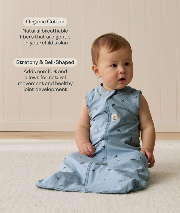 Infant wearing a blue sleeveless Sleep Sack 1.0 TOG Dragonflies with text highlighting organic cotton and stretchy & bell-shaped design.