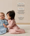 Two babies wearing long-sleeved sleep sack sit on a carpet. Next to them, text highlights features including 
