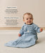 Smiling infant wearing a sleeved Sleep Sack 1.0 TOG Dragonflies with text highlighting organic cotton and stretchy & bell-shaped design.