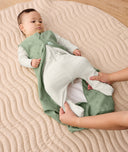 Infant getting changed into a ergoPouch Sleeping Sack 1.0 TOG Willow