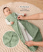 Baby lying on a padded mat while an adult adjusts the zipper of the baby's green sleeveless sleep sack with text overlay highlighting two-way zip design for easy diaper changing.
