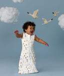 Infant in a cool ergoPouch Sleep Sack 1.0 TOG Daydream with birds and clouds in the background, perfect for everyday