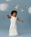Infant in a cool ergoPouch Sleep Sack 1.0 TOG Daydream with birds and clouds in the background, perfect for everyday