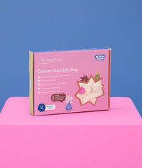 Packaging shot of ergoPouch Cocoon Swaddle Sack 1.0 TOG Birthday Blobs