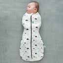 Baby is wearing an ergoPouch Cocoon Swaddle Sack 0.2 TOG Clouds