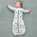 Baby wearing a Cocoon Swaddle Sack with is arms out