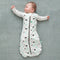 Baby wearing a Cocoon Swaddle Sack with is arms out
