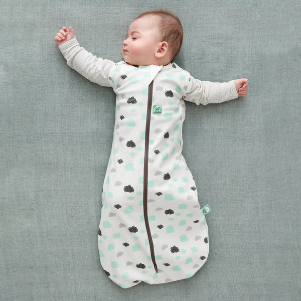 Baby wearing a Cocoon Swaddle Sack with is arms out