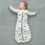 Baby wearing a Cocoon Swaddle Sack with is arms out