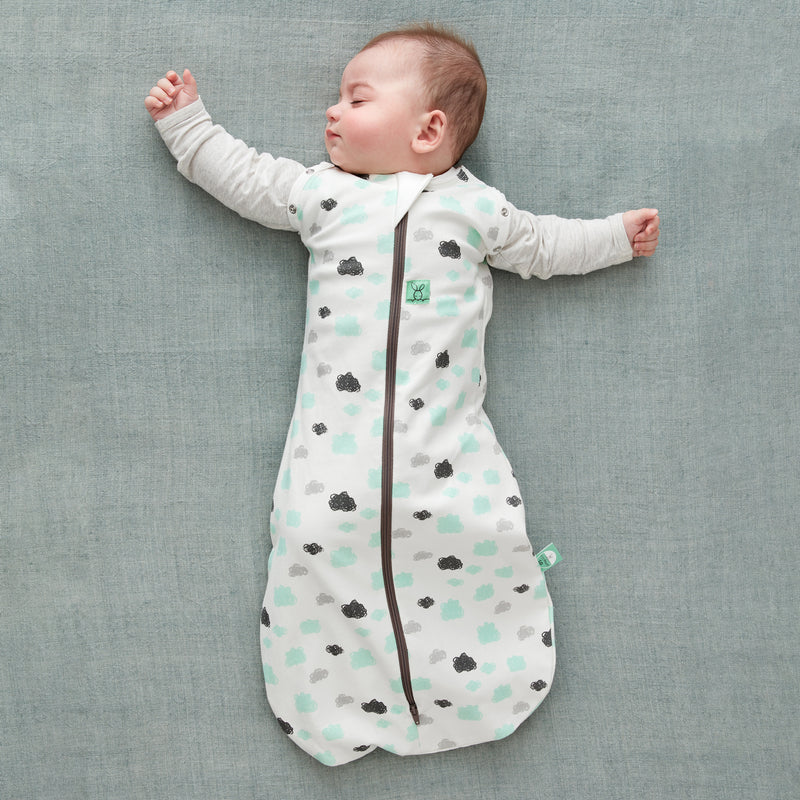 Baby wearing a Cocoon Swaddle Sack with is arms out