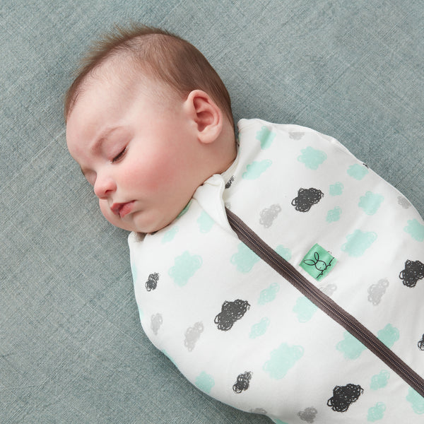 Sleeping baby swaddled in ergoPouch Cocoon Swaddle Sack
