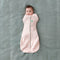 Baby wearing a Cocoon Swaddle Sack arms in