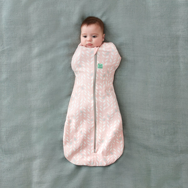 Baby wearing a Cocoon Swaddle Sack arms in