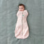 Baby wearing a Cocoon Swaddle Sack arms in