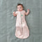 Baby wearing a Cocoon Swaddle Sack 1.0 TOG with its arms out