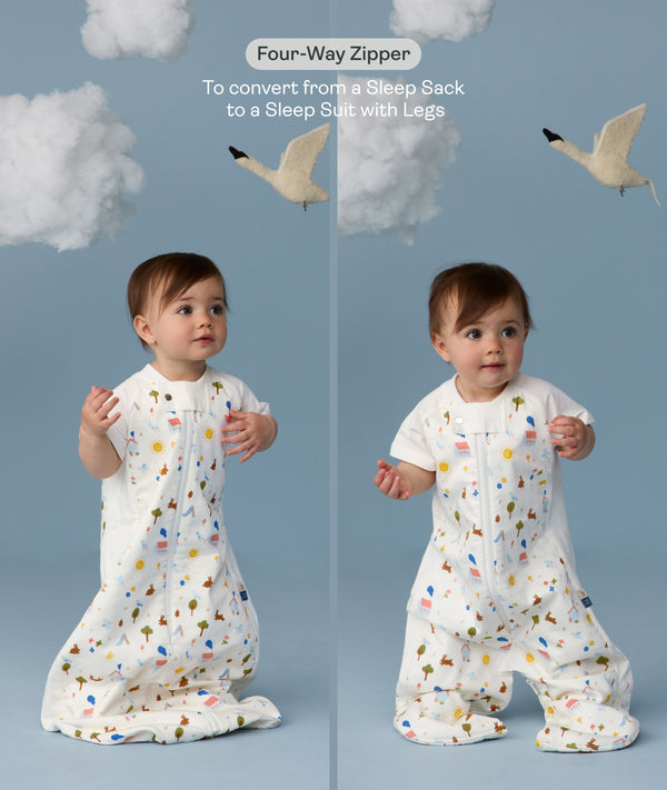Two children wearing an ergoPouch Sleep Suit Sack 1.0 TOG Daydream, a sleeping bag that converts to a sleep suit with legs by a four-way zipper feature. 