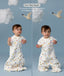 Two children wearing an ergoPouch Sleep Suit Sack 1.0 TOG Daydream, a sleeping bag that converts to a sleep suit with legs by a four-way zipper feature. 