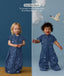 Two children wearing an ergoPouch Sleep Suit Sack 1.0 TOG Starbeam, a sleeping bag that converts to a sleep suit with legs by a four-way zipper feature. 