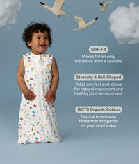 Infant wearing a ergoPouch Sleep Sack 1.0 TOG Daydream with text about its features on a blue background with swans and clouds.