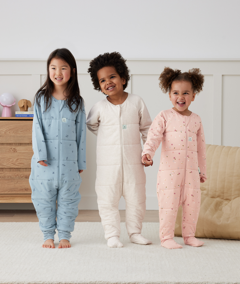 Three preschoolers holding hands wearing ergoPouch Sleep Onesies 2.5 TOG, sleepwear that is GOTS-certified organic cotton