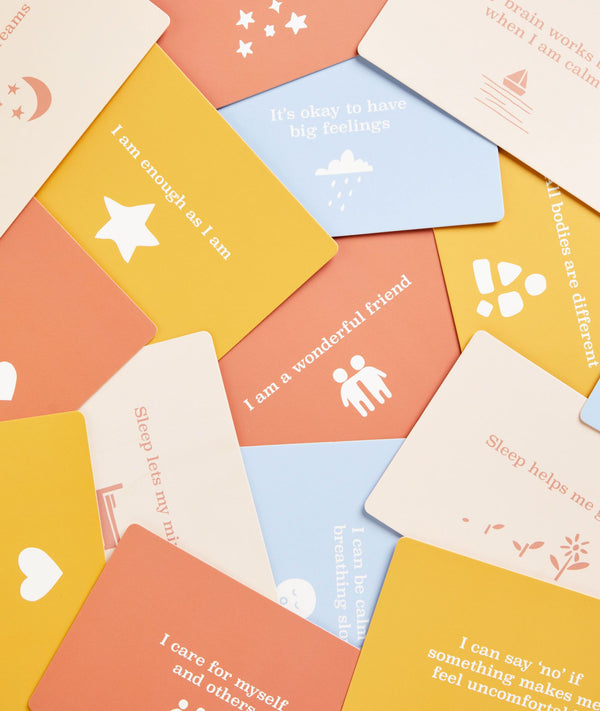 Cards scattered from the ergoPouch Hello, Sleep! Bedtime Affirmations for Kids