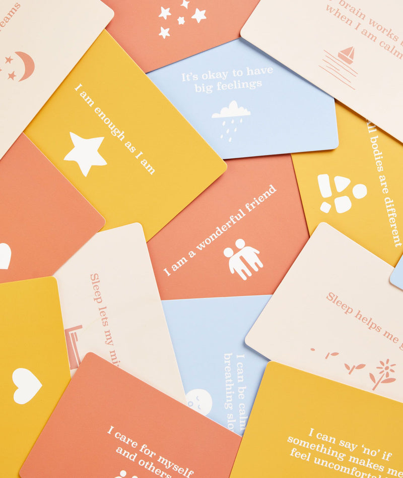 Cards scattered from the ergoPouch Hello, Sleep! Bedtime Affirmations for Kids