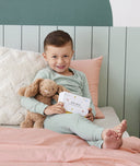 Preschooler holding ergoPouch Hello, Sleep! Bedtime Affirmations for Kids