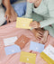 ergoPouch Hello, Sleep! Bedtime Affirmations for Kids cards scattered on bed