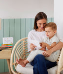 Mom and toddler reading ergoPouch Hello, Sleep! Bedtime Affirmations for Kids on a chair