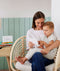 Mom and toddler reading ergoPouch Hello, Sleep! Bedtime Affirmations for Kids on a chair
