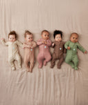 A group of newborns wearing ergoPouch Long Sleeve Romper 1.0 TOG 
