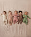 A group of newborns wearing ergoPouch Long Sleeve Romper 1.0 TOG 