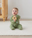 Newborn sitting in ergoPouch Long Sleeve Romper 1.0 TOG Moss