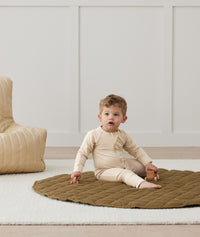 Infant sitting in ergoPouch Long Sleeve Romper 1.0 TOG Vanilla