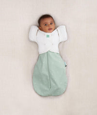 Newborn wearing a ergoPouch Butterfly Cardi Natural, for arms up sleeping and help with arms-out transition