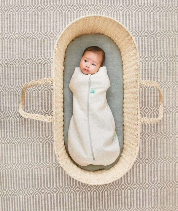Newborn being swaddled in a ergoPouch Cocoon Swaddle Sack 0.2 TOG Grey Marle