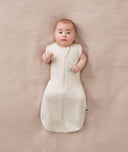Baby sleeping with arms out in a ergoPouch Cocoon Swaddle Sack 1.0 TOG Oatmeal Marle
