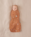 Newborn being swaddled in ergoPouch Cocoon Swaddle Sack 1.0 TOG Sunny