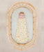 Newborn wearing an ergoPouch Cocoon Swaddle Sack 0.2 TOG Critters with arms in