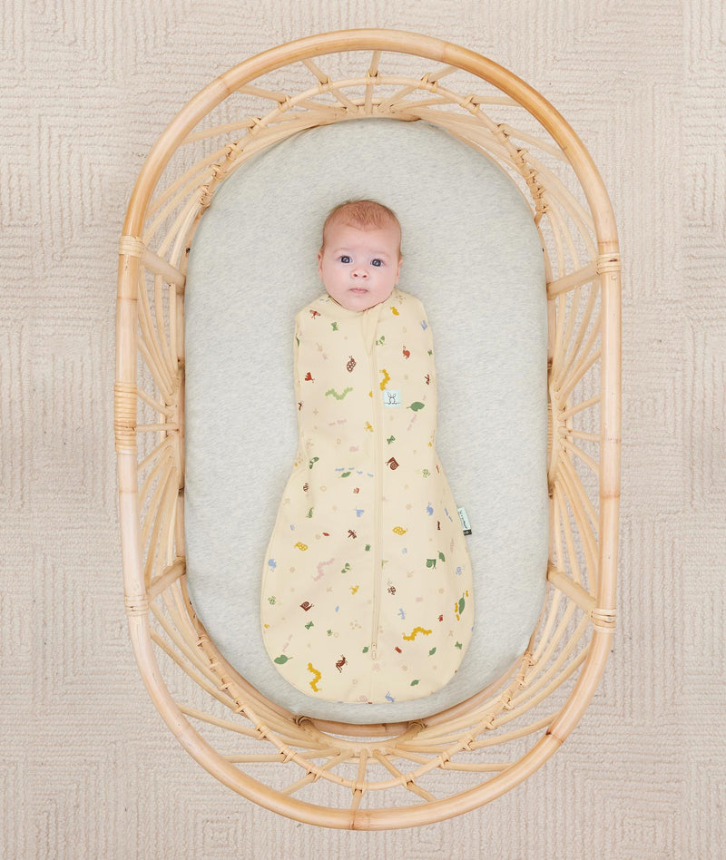 Newborn wearing an ergoPouch Cocoon Swaddle Sack 0.2 TOG Critters with arms in