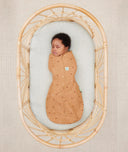 Newborn wearing an ergoPouch Cocoon Swaddle Sack 0.2 TOG Honey Bees with arms in