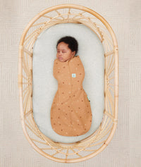 Newborn wearing an ergoPouch Cocoon Swaddle Sack 0.2 TOG Honey Bees with arms in