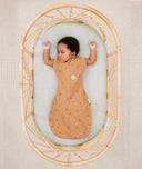 Baby sleeping with arms out in ergoPouch Cocoon Swaddle Sack 0.2 TOG Honey Bees