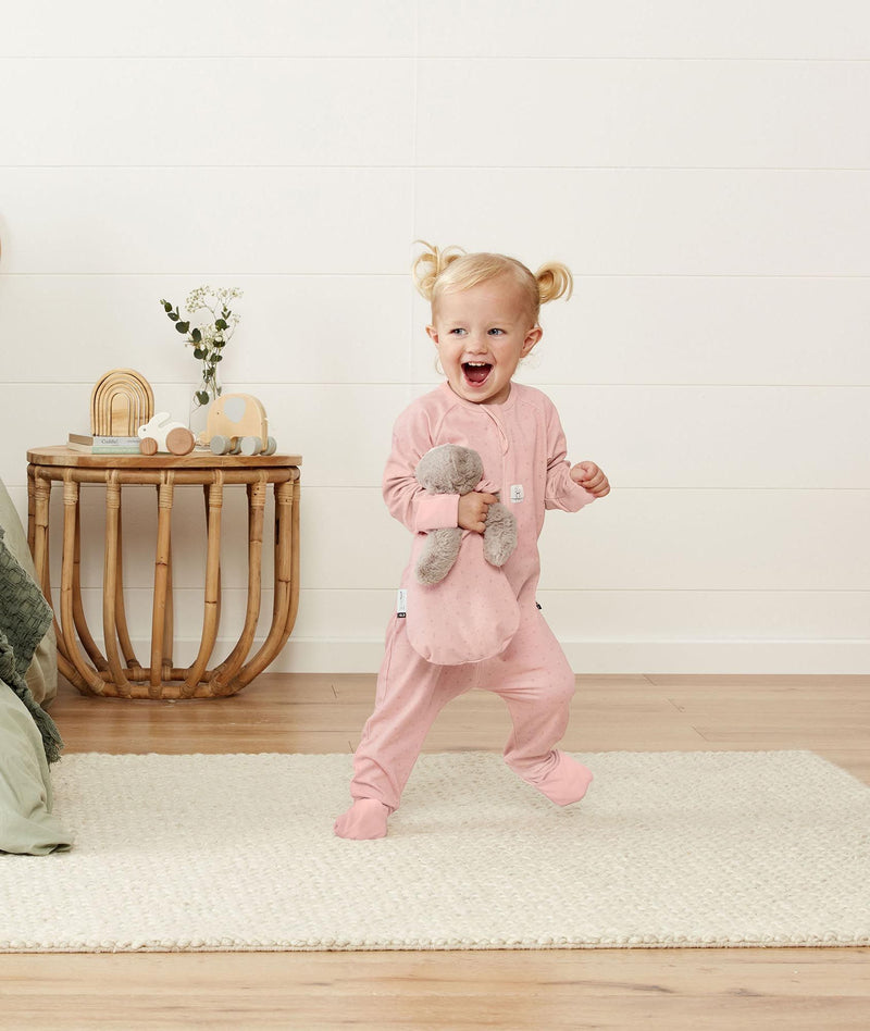 Infant standing wearing ergoPouch Long Sleeve Romper 1.0 TOG Berries